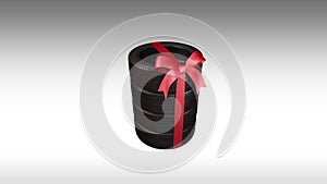 The tyres are stacked and packaged as a gift, wrapped red ribbon and bow, alpha matte