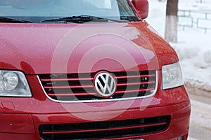 Tyumen, Russia-January 25, 2024: Red Volkswagen car stands out with a dusting of snow on its hood, signaling a chilly