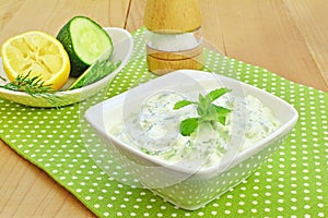 Tzatziki sauce. Greek cucumber yogurt dip in white bowl