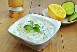 Tzatziki sauce. Greek yogurt cucumber dip in white bowl