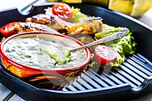 Tzatziki sauce. Tzatziki dressing. Tzatziki dressing with grilled chicken legs and fresh vegetable,lettuce leaf and cherry