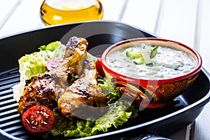 Tzatziki sauce. Tzatziki dressing. Tzatziki dressing with grilled chicken legs and fresh vegetable,lettuce leaf and cherry