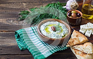 Tzatziki sauce in wooden bowl