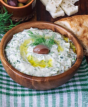 Tzatziki sauce in wooden bowl