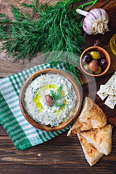 Tzatziki sauce in wooden bowl