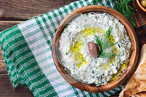 Tzatziki sauce in wooden bowl