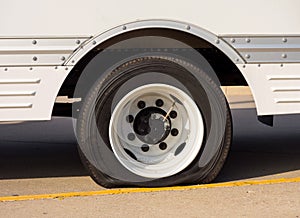 A u-haul vehicle with a flat tire at a rest area in the summertime