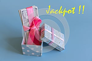 U.S. dollars banknotes laying in bow decorated gift box. dollars jackpot prize. Opened gift and dollars. Gift box with banknote of