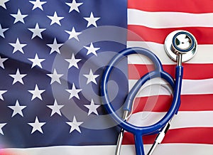U.S. health care. Medical stethoscope on a U.S. flag. US health insurance concept