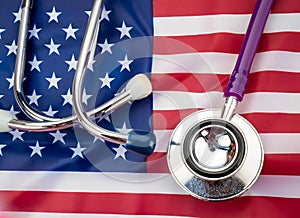 U.S. health care. Medical stethoscope on a U.S. flag. US health insurance concept