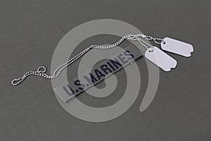 U.S. MARINES Branch Tape with dog tags on olive drab uniform