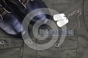 U.S. MARINES Tape with dog tags and boots on olive green uniform photo
