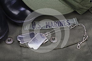 U.S. MARINES Tape with dog tags and boots on olive green uniform photo