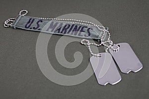 U.S. MARINES Tape with dog tags on olive green uniform