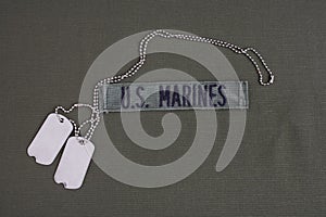 U.S. MARINES Tape with dog tags on olive green uniform