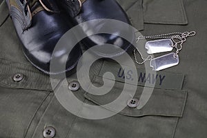 U.S. Navy Branch Tape with dog tags on olive green uniform photo