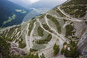 U-shape curved road towards Towers of Fraele, a touristic attraction in North Valtellina, Italy