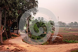 U Shaped dirt road of a rural village. Summer Landscape. Rural India. Bankura West Bengal India South Asia Pacific