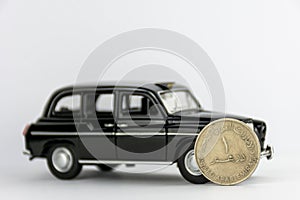 UAE 1 dirham coin on black car.