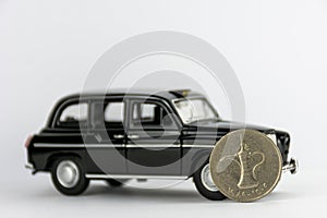 UAE 1 dirham coin on black car.