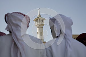 UAE Dubai group of traditionally dressed Muslim men perform a song for visitors to the Bastakia