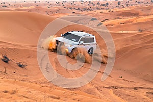 UAE, Fujairah 2017.19.11 Off-road safari on jeeps SUVs in the Arab orange-red sands desert in the sunset sun