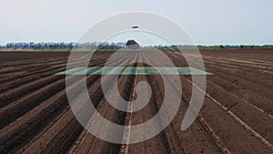 UAV drone, copter with digital camera flies over, scanning newly plowed agricultural field, Smart agriculture. concept