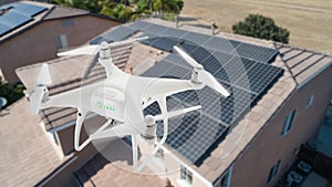 UAV Drone Inspecting Solar Panels On Large House
