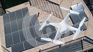 UAV Drone Inspecting Solar Panels On Large House photo