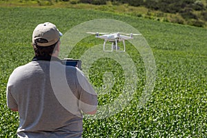 UAV Drone Pilot Flying and Gathering Data Over Country Farm Land