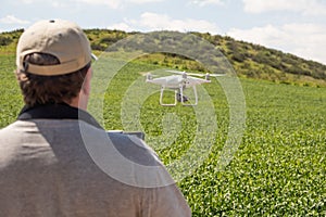 UAV Drone Pilot Flying and Gathering Data Over Country Farm Land