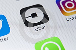 Uber application icon on Apple iPhone X screen close-up. Uber app icon. Uber is taxi car transportation application.