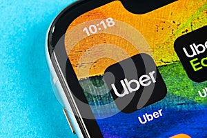 Uber application icon on Apple iPhone X screen close-up. Uber app icon. Uber is taxi car transportation