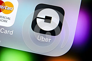 Uber application icon on Apple iPhone X screen close-up. Uber app icon. Uber is taxi car transportation