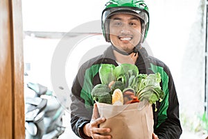 Uber delivery courier looking at camera