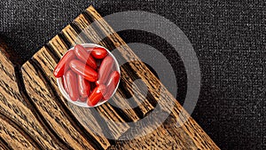 Ubiquinol supplement softgels on a wooden desk. dietary supplements top view. mental wellbeing and personal health concept photo