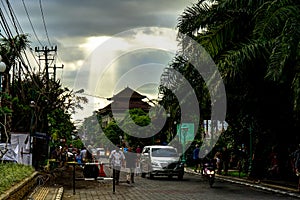 Ubud Bali Street Scene with sunrays and people walking