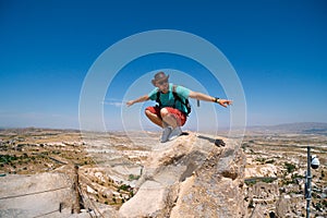 Uchisar Castle. Tourist at the top of the fortress, mountains, view of Cappadocia. Man photographer, male Traveler at Destinaton.