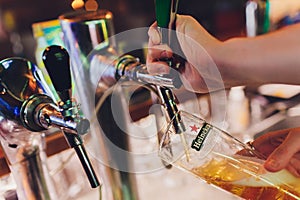 Ufa, Russia, 1 July, 2019: Heineken bartender poured beer into a glass.