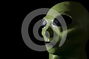 UFO and extraterrestrial life encounter of third degree concept theme with close up on the face of a green alien with high