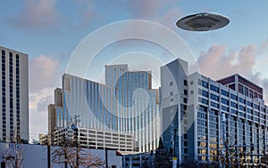 UFO Flying Saucer hovering above tall buildings