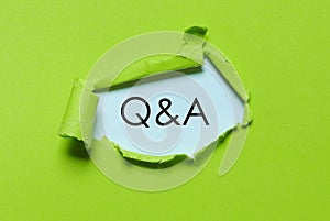 UFO green torn paper written with Q&A. Questions and answers.