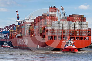 Ug boat pulls large container ship