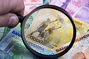 Ugandan shilling in a magnifying glass