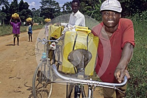 Ugandans lugging with drinking water and bananas