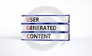 UGC user generated content symbol. Concept words UGC user generated content on books on a beautiful white table white background.