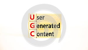 UGC user generated content symbol. Concept words UGC user generated content on wooden blocks on a beautiful white table white