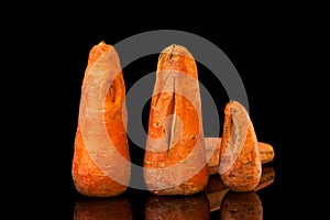 Ugly carrots on a black background. Copy space. Horizontal orientation