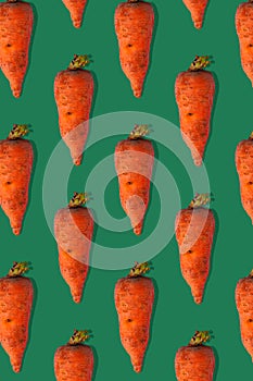 Ugly carrots regular pattern with shadows pastel background. Big deformed vegetables on pastel background.Trendy flatlay