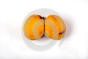 Ugly funny ripe tasty accrete apricot on a white background